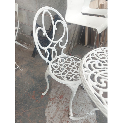 1234 - Six items to include white cast aluminium patio table with one matching chair and four white bar sto... 