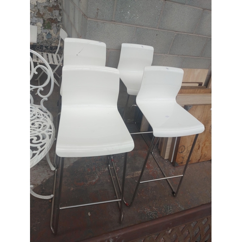 1234 - Six items to include white cast aluminium patio table with one matching chair and four white bar sto... 