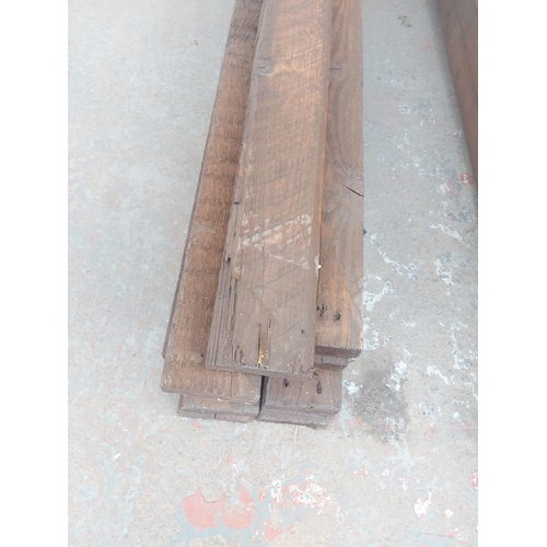 1255 - Thirteen lengths of stained timber - approx. 10' long x 4