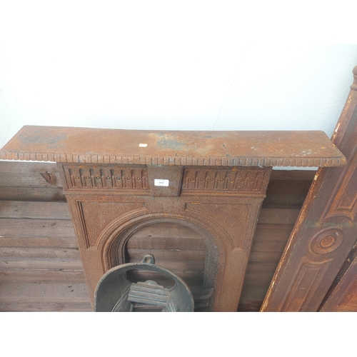 1259 - A complete vintage cast iron bedroom fireplace comprising surround with mantel piece, fire back with... 