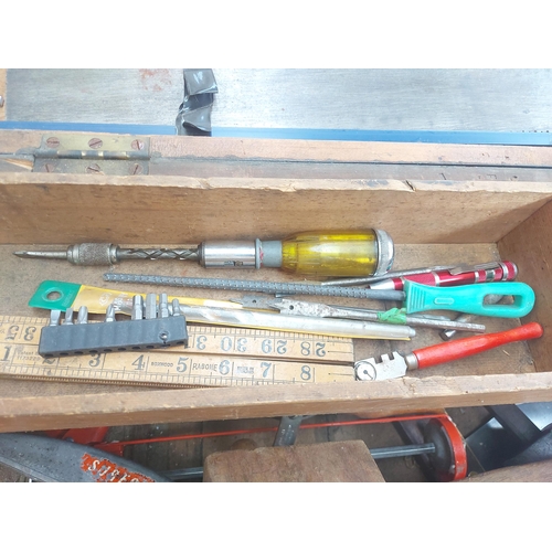 1298 - A vintage wooden toolbox containing Stanley hand drill and ratchet screwdriver, wood chisels, set sq... 