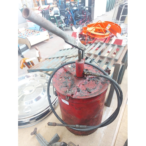 1318 - Two items, one red metal Alemite grease bucket with hand pump and one vintage mole clamp on manually... 