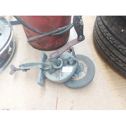 1318 - Two items, one red metal Alemite grease bucket with hand pump and one vintage mole clamp on manually... 