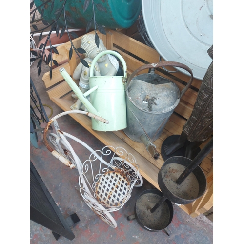 1359 - A collection of various items to include galvanised watering can, wooden planters, green metal garde... 