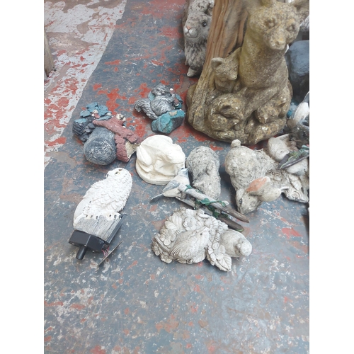 1366 - A collection of various cast stone, resin and plastic garden ornaments to include badgers, ducks, ra... 