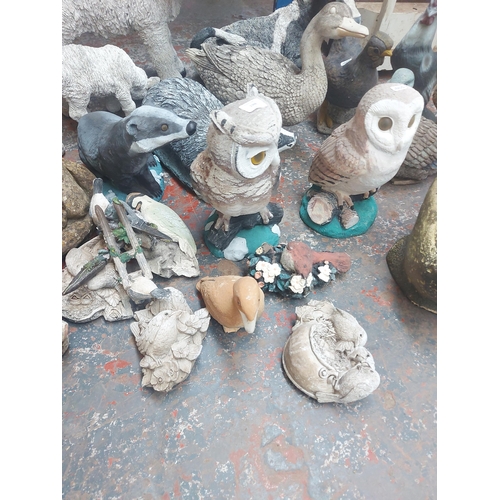 1366 - A collection of various cast stone, resin and plastic garden ornaments to include badgers, ducks, ra... 