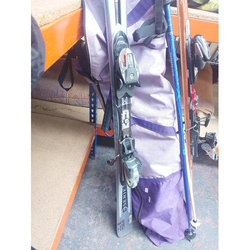 1388 - A purple ski bag containing two pairs of snow skis, one Volki P60 custom, one Atomic device 310 and ... 