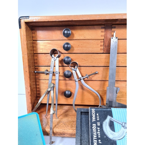 359A - A mid 20th century oak seven drawer engineers tool cabinet containing various tools and equipment to... 