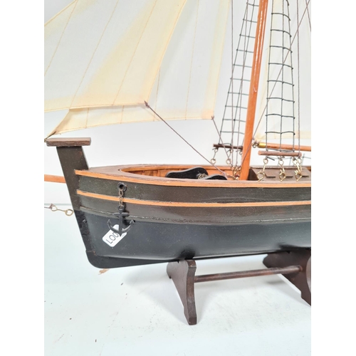 360 - A model wooden ship on stand with linen sails - approx. 56cm high x 63cm wide