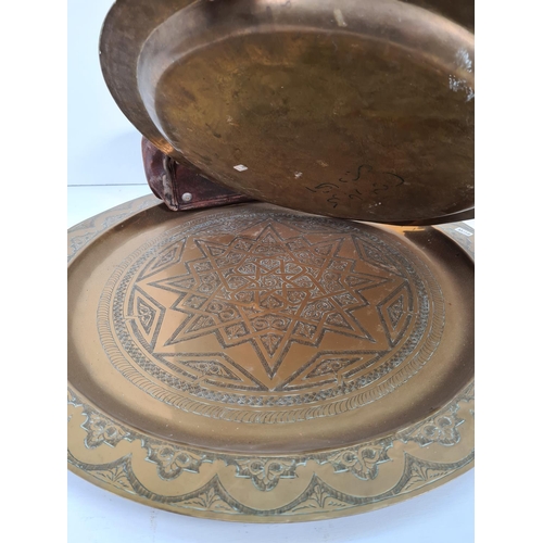 289 - Four items, three Middle Eastern brass wall chargers - the largest approx. 64cm diameter and one vin... 