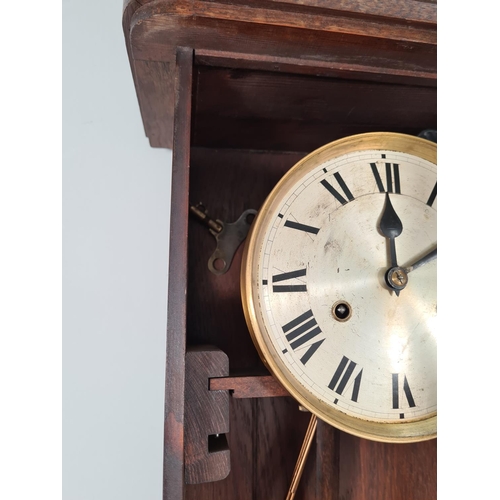 301 - A vintage oak cased chiming wall clock with pendulum and key - approx. 80cm high x 33cm wide x 17.5c... 