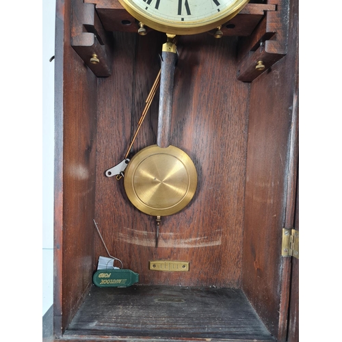 301 - A vintage oak cased chiming wall clock with pendulum and key - approx. 80cm high x 33cm wide x 17.5c... 