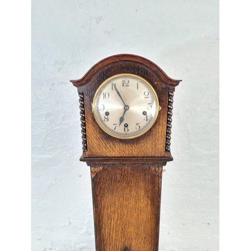 302 - A 1920s oak cased presentation granddaughter clock with German movement - approx. 132cm high x 26cm ... 