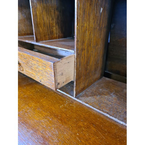 1004A - An Edwardian inlaid mahogany bureau bookcase with shell and fan inlay, upper swan neck pediment, two... 