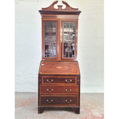 1004A - An Edwardian inlaid mahogany bureau bookcase with shell and fan inlay, upper swan neck pediment, two... 