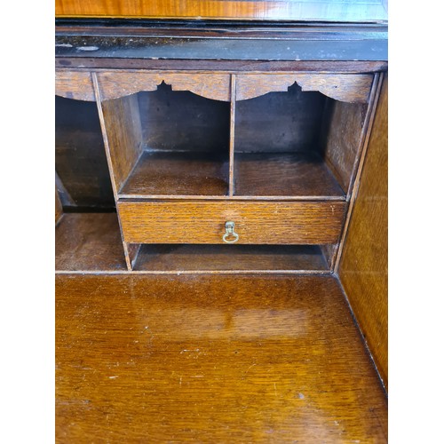 1004A - An Edwardian inlaid mahogany bureau bookcase with shell and fan inlay, upper swan neck pediment, two... 