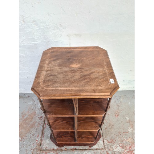 1021 - An Edwardian stained pine and mahogany revolving three tier bookcase - approx. 99cm high x 52cm squa... 