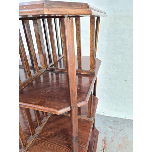 1021 - An Edwardian stained pine and mahogany revolving three tier bookcase - approx. 99cm high x 52cm squa... 