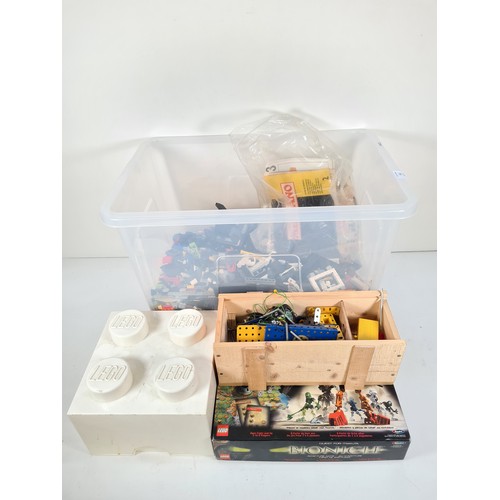 311 - A large collection of assorted Lego and Meccano model building parts with instruction manuals and st... 