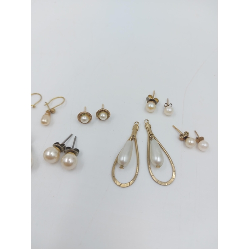 54 - Six pairs of yellow metal faux pearl earrings and two singular to include a pair of hallmarked 9ct g... 