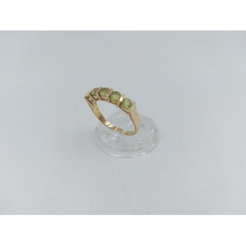 59A - A 9ct gold peridot five stone ring, size P - approx. gross weight 2.7 grams