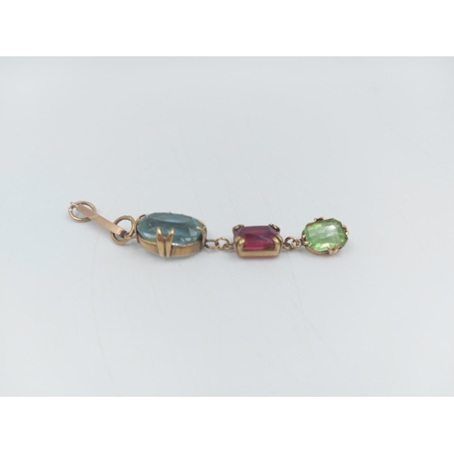 67 - A stamped 9ct gold aquamarine, ruby and emerald paste droplet necklace pendant - approx. gross weigh... 