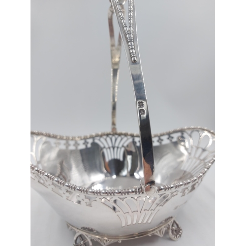 162 - A hallmarked Sheffield silver Martin Hall & Co pierced handled footed basket, dated 1918 - gross app... 