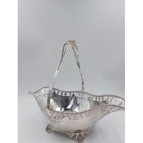 162 - A hallmarked Sheffield silver Martin Hall & Co pierced handled footed basket, dated 1918 - gross app... 