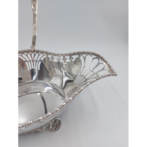 162 - A hallmarked Sheffield silver Martin Hall & Co pierced handled footed basket, dated 1918 - gross app... 