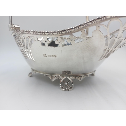 162 - A hallmarked Sheffield silver Martin Hall & Co pierced handled footed basket, dated 1918 - gross app... 