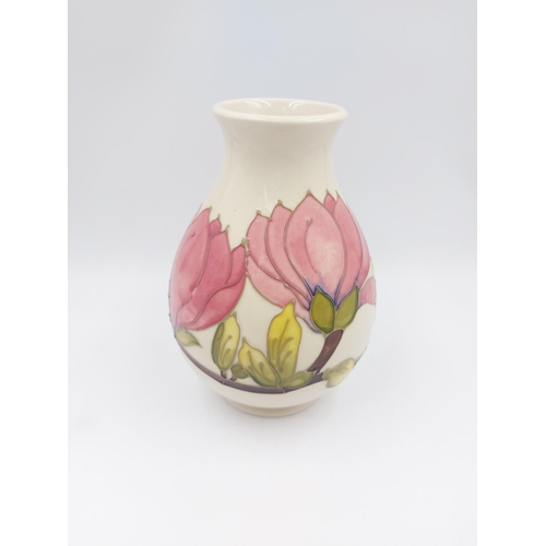 242 - A Moorcroft Pottery vase in the Pink Magnolia design - approx. 19cm high