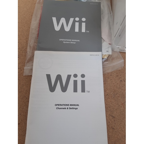 1153 - A collection of Nintendo Wii items to include three white RVL-001 consoles, instruction manuals, Wii... 