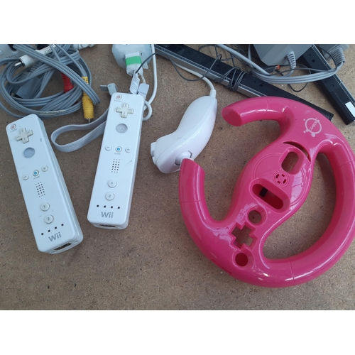 1153 - A collection of Nintendo Wii items to include three white RVL-001 consoles, instruction manuals, Wii... 