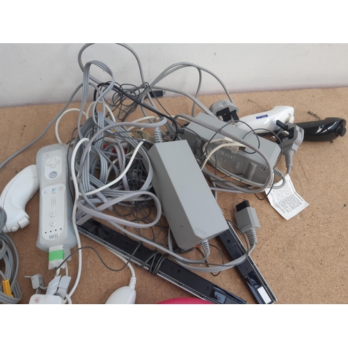 1153 - A collection of Nintendo Wii items to include three white RVL-001 consoles, instruction manuals, Wii... 