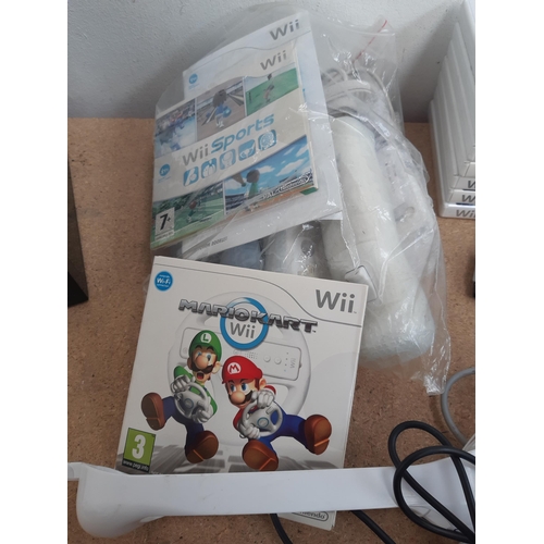 1154 - A collection of Nintendo Wii items to include black RVL-001 console, white RVL-001 console, Wii remo... 