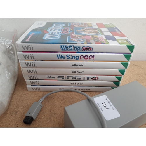 1154 - A collection of Nintendo Wii items to include black RVL-001 console, white RVL-001 console, Wii remo... 