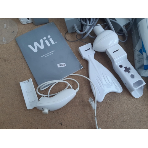 1155 - A collection of Nintendo Wii items to include two white RVL-001 consoles, boxed Dancing Stage mat, W... 