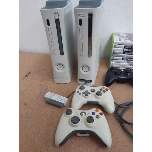 1160 - A collection of Xbox 360 items to include two consoles, controllers, game discs ad power adaptor