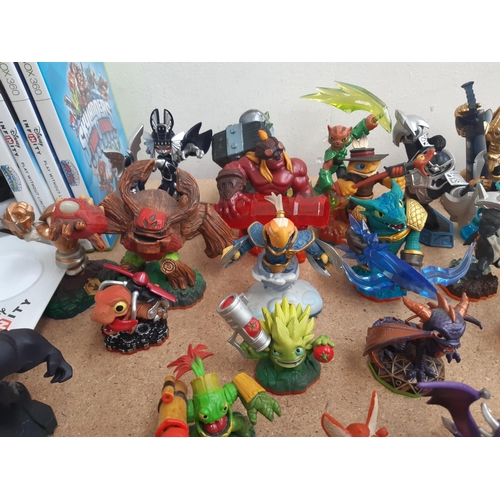 1161 - A collection of console gaming accessories and figures to include Skylanders, Star Wars and Marvel f... 