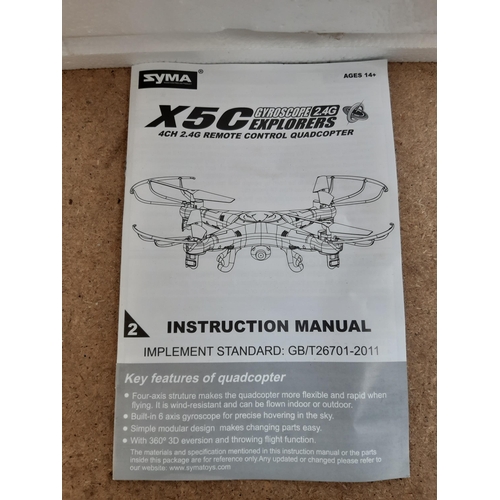 1162 - A boxed Syma X5C-1 four channel remote control quadcopter with instruction manual