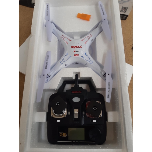 1162 - A boxed Syma X5C-1 four channel remote control quadcopter with instruction manual