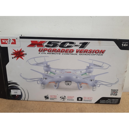 1162 - A boxed Syma X5C-1 four channel remote control quadcopter with instruction manual