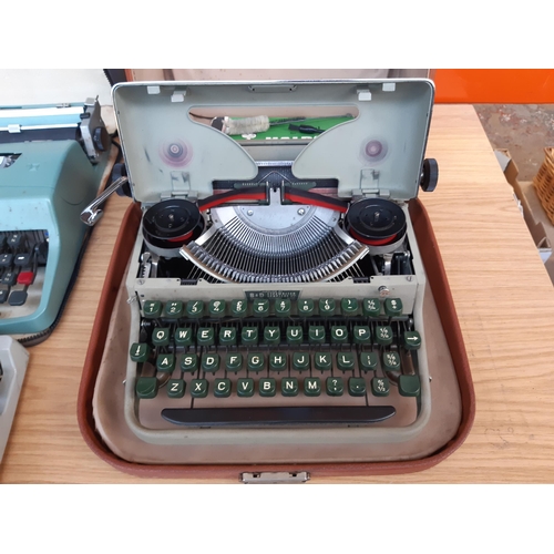 1191 - Four vintage cased portable typewriters, one green Olivetti Lettera 32, one green Halda of Sweden wi... 