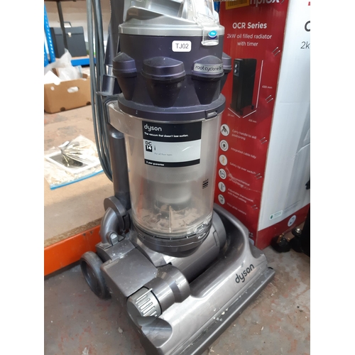 1195 - A purple and grey Dyson DC14 upright bagless vacuum cleaner