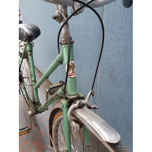 1213 - A vintage green Coventry Eagle lady's town bike with rear carrier, sprung saddle and five speed Altu... 