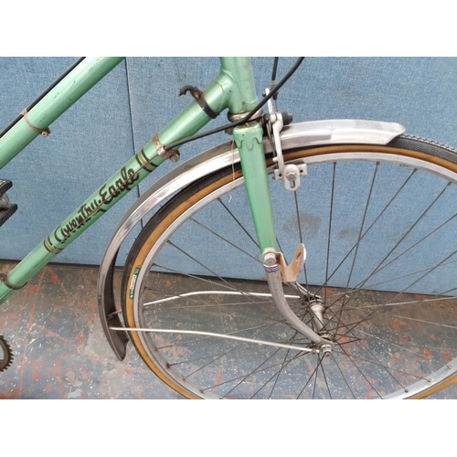 1213 - A vintage green Coventry Eagle lady's town bike with rear carrier, sprung saddle and five speed Altu... 