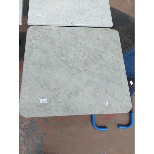 1241 - A marble top bistro/café table on black metal pedestal supports - approx. 77cm high x 60cm wide x 65... 