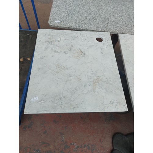 1241A - A marble top bistro/café table on black metal pedestal supports - approx. 77.5cm high x 60cm wide x ... 