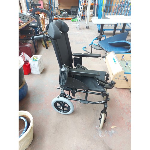 1244A - A black Invacare Action 3 wheelchair with head and foot rests