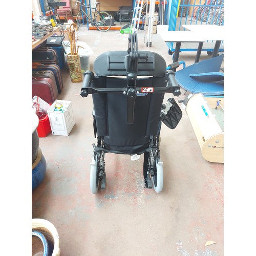 1244A - A black Invacare Action 3 wheelchair with head and foot rests